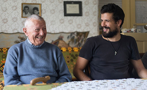 Grandfather and older grandson laughing